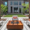 a patio with chairs and tables and a building in the background