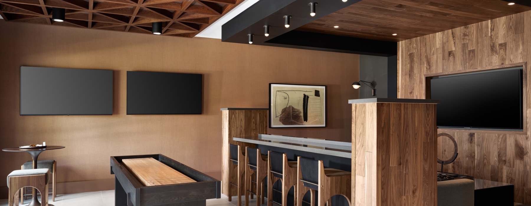 social room with tvs and game areas