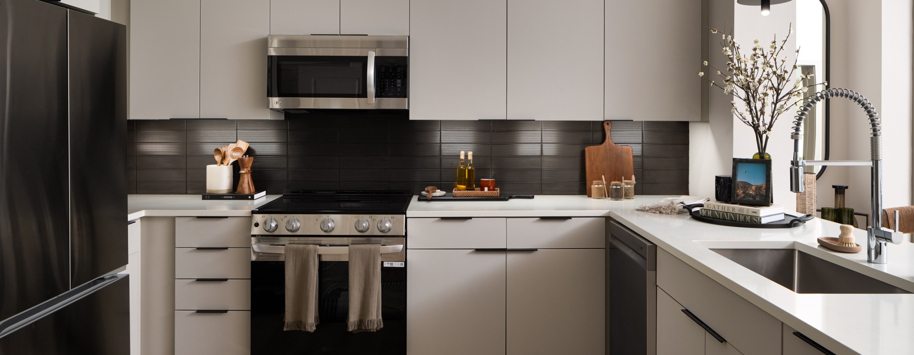 a kitchen with off-white cabinets