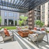 a courtyard with a few chairs and a covered patio